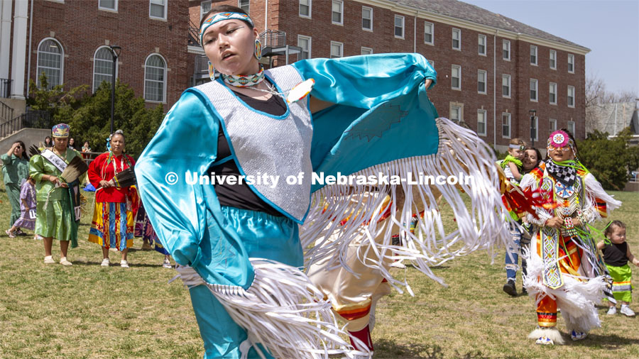 Fringe on the regalia of Stevie Horse, a member of the Ponca and Lakota tribe, flutters in the wind as she dances during an intertribal moment at the April 23 powwow. 2022 UNITE powwow to honor graduates (K through college). Held April 23 on the greenspace along 17th Street, immediately west of the Willa Cather Dining Center. This was UNITE’s first powwow in three years. The MC was Craig Cleveland Jr. Arena director was Mike Wolfe Sr. Host Northern Drum was Standing Horse. Host Southern Drum was Omaha White Tail. Head Woman Dancer was Kaira Wolfe. Head Man Dancer was Scott Aldrich. Special contest was a Potato Dance. April 23, 2023. Photo by Troy Fedderson / University Communication.